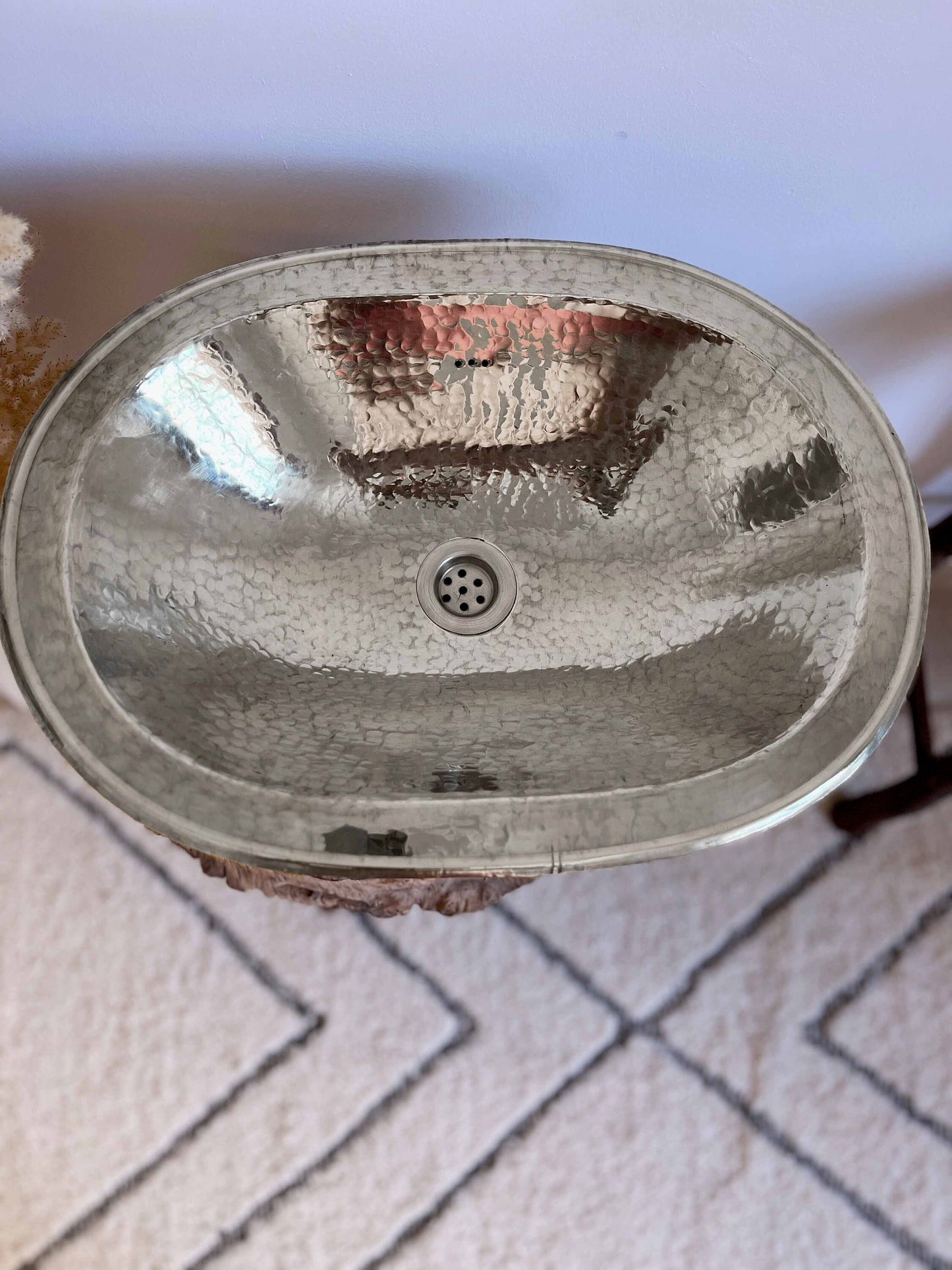 a bathroom sink sitting on top of a rug