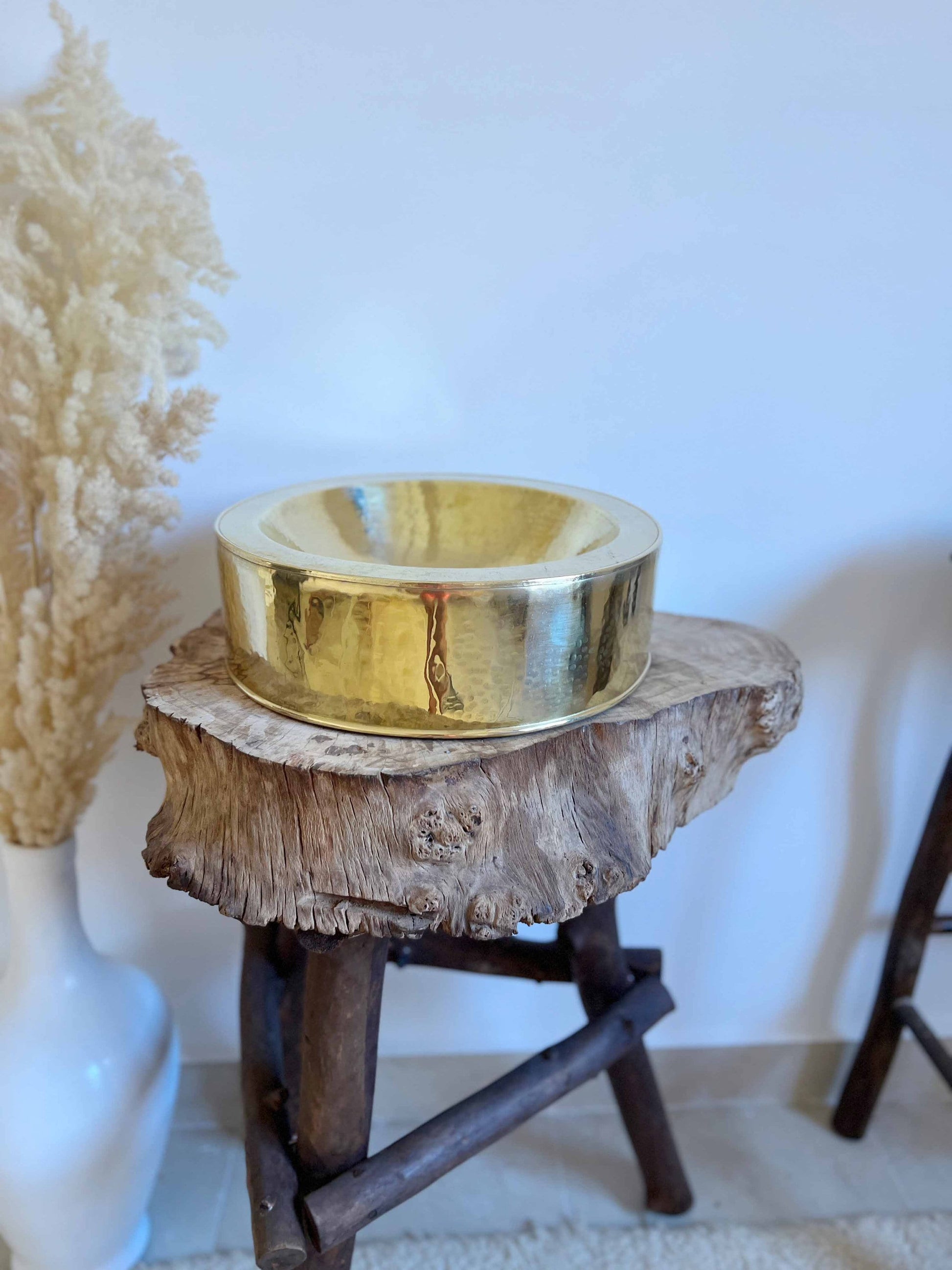 a gold bowl sitting on top of a wooden table