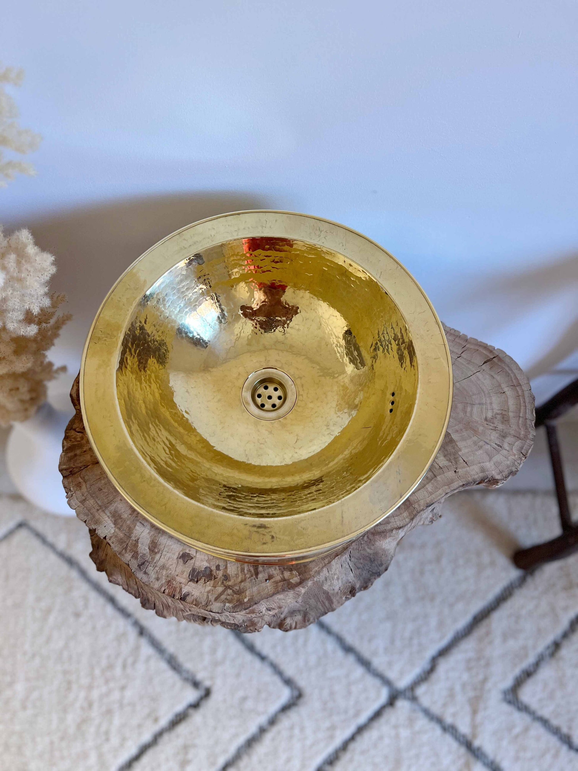 a golden bowl sitting on top of a tree stump