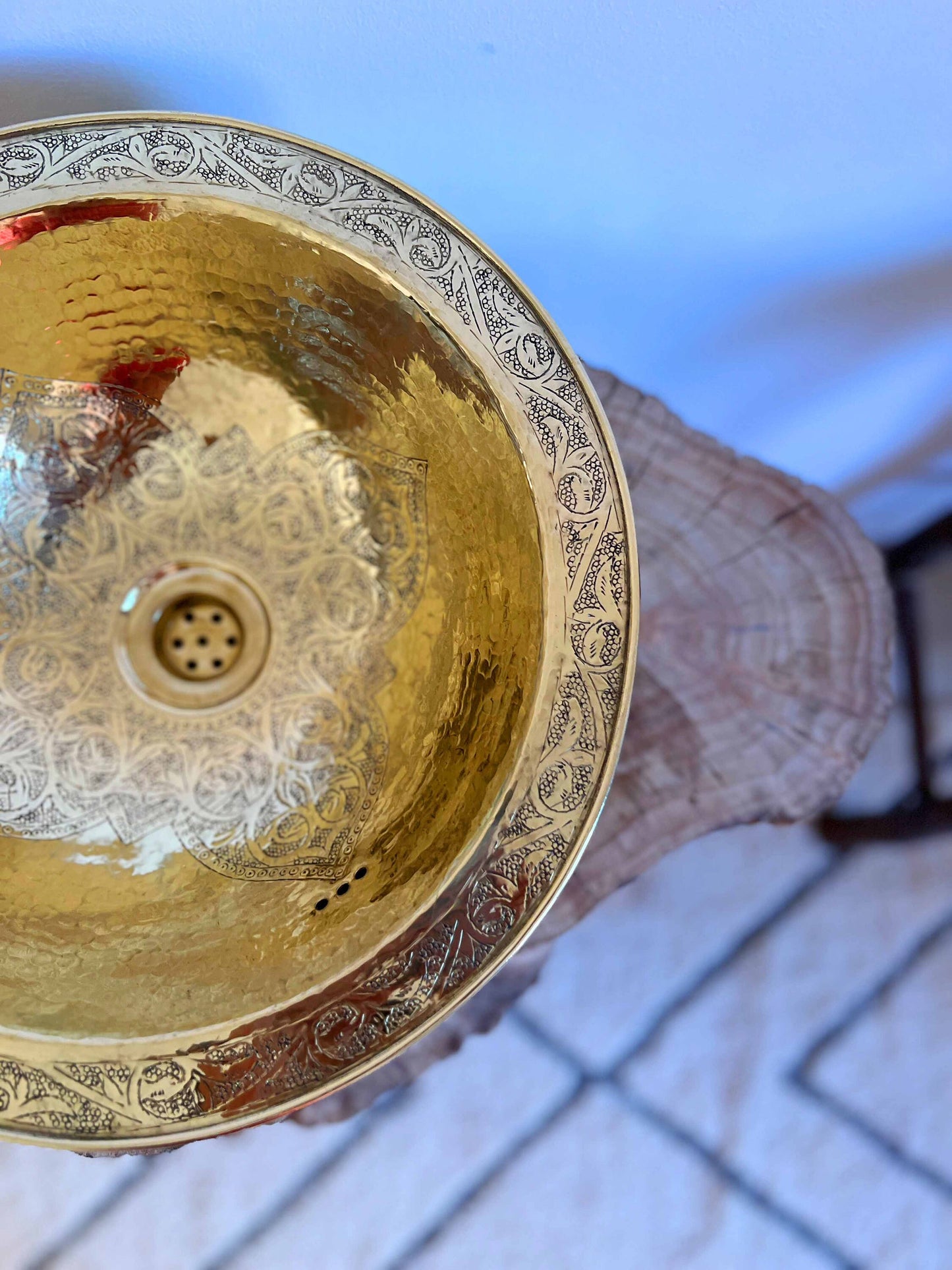 a person holding a metal bowl in their hand