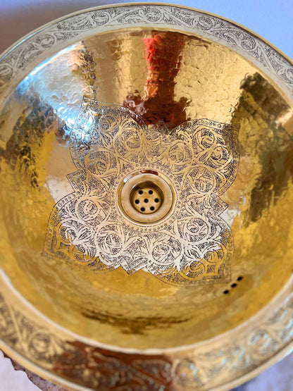 a golden bowl with a decorative design on it