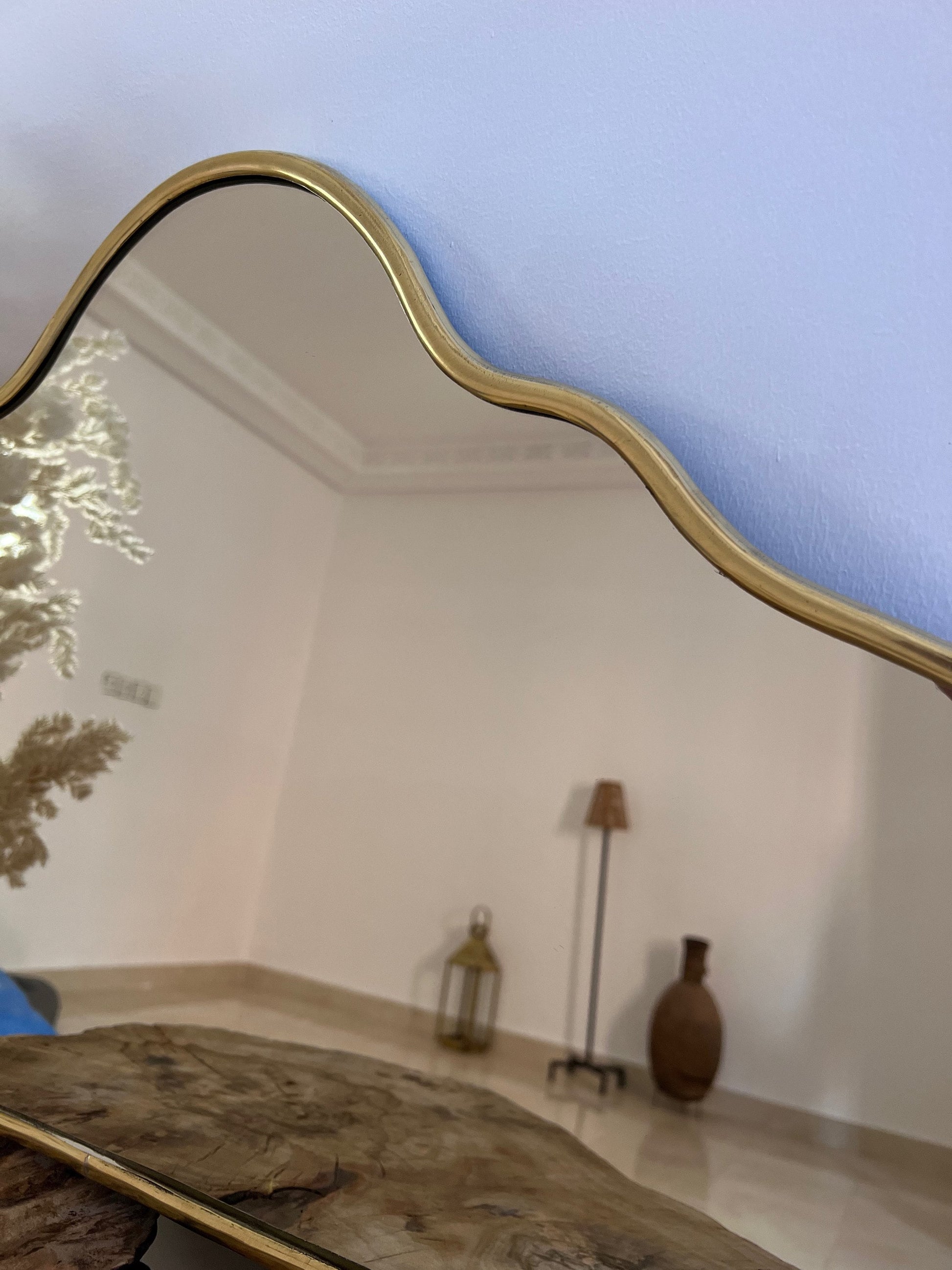a large mirror sitting on top of a wooden table