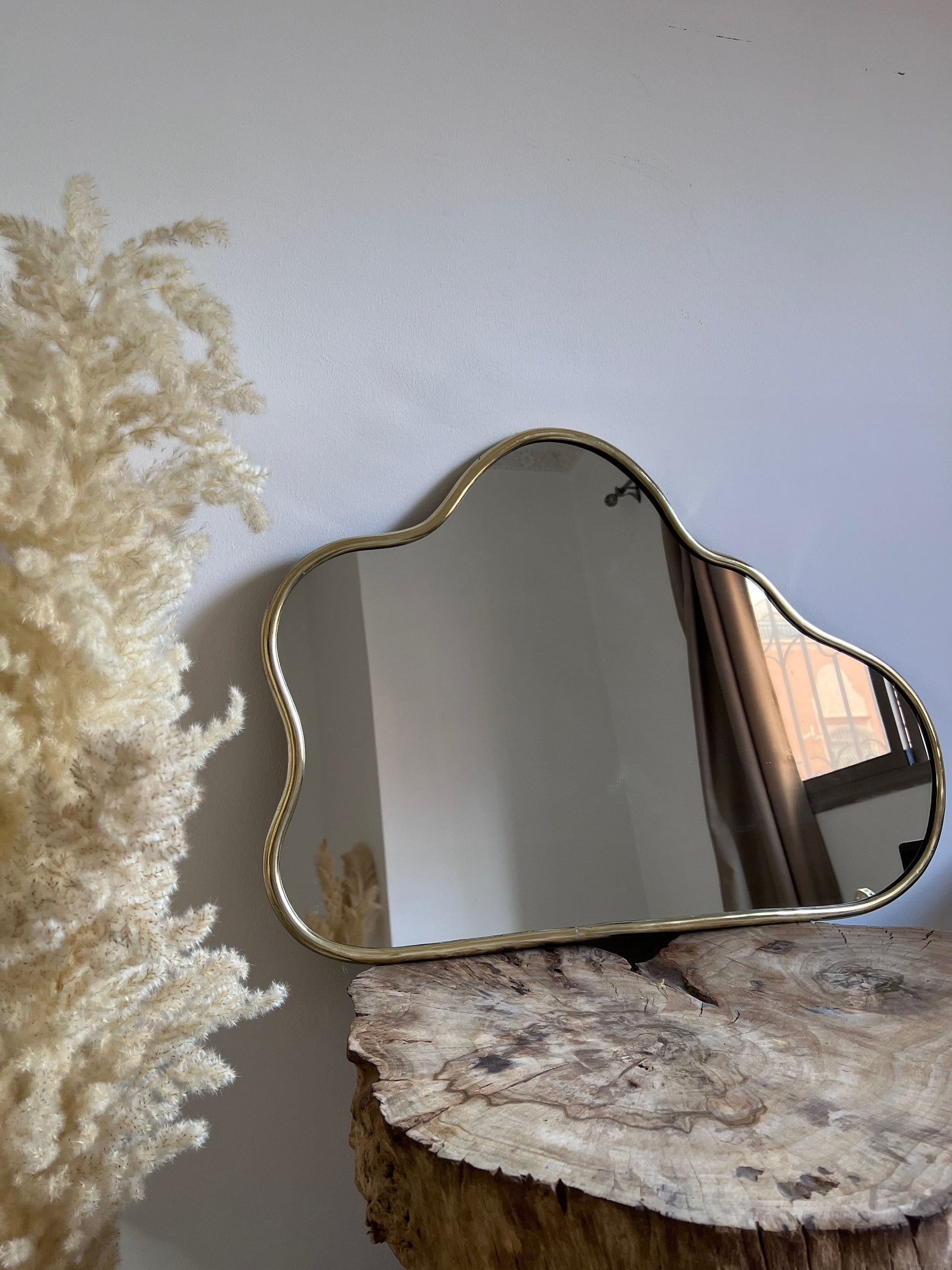 a mirror sitting on top of a tree stump