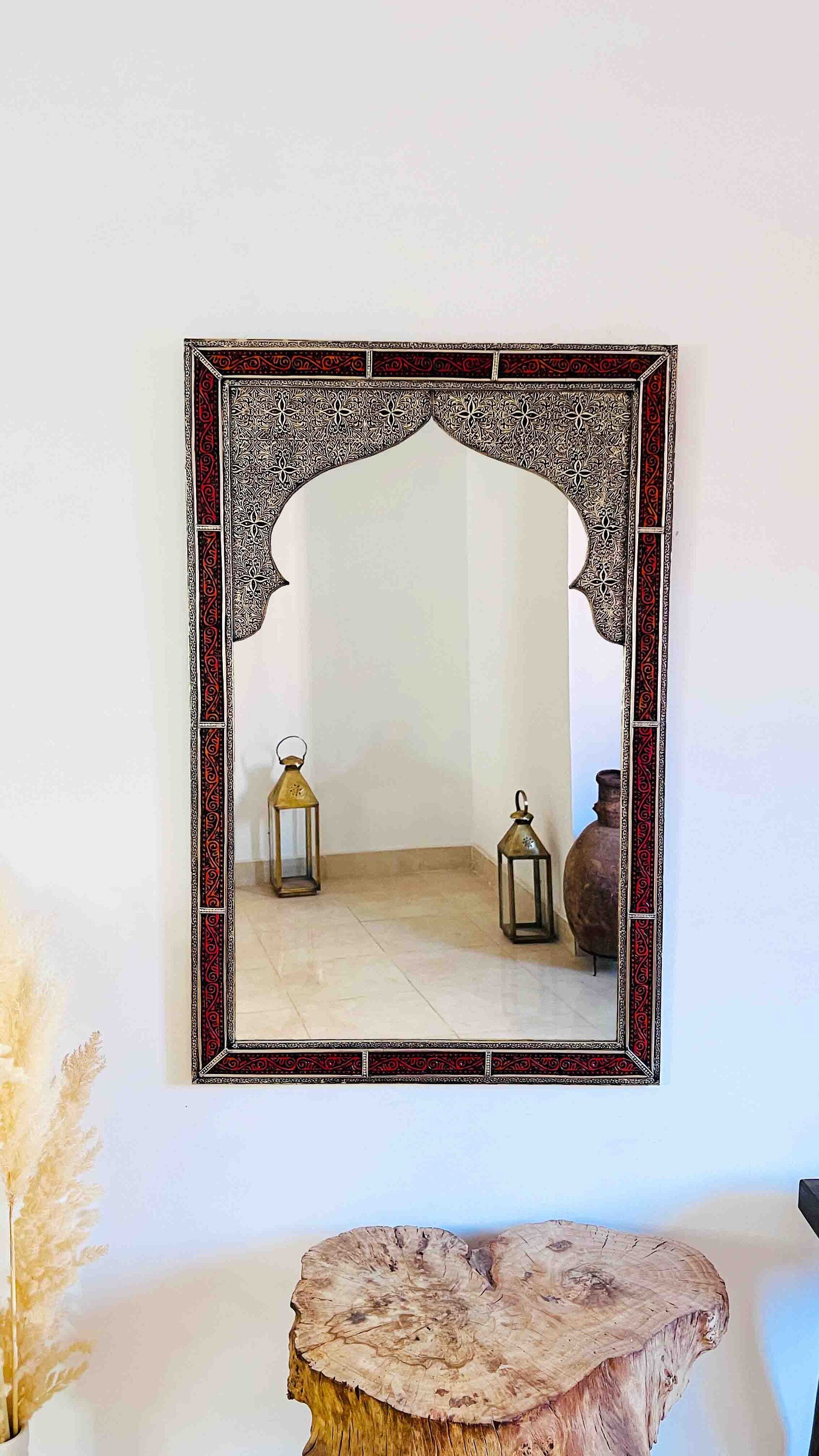 a mirror hanging on a wall next to a table