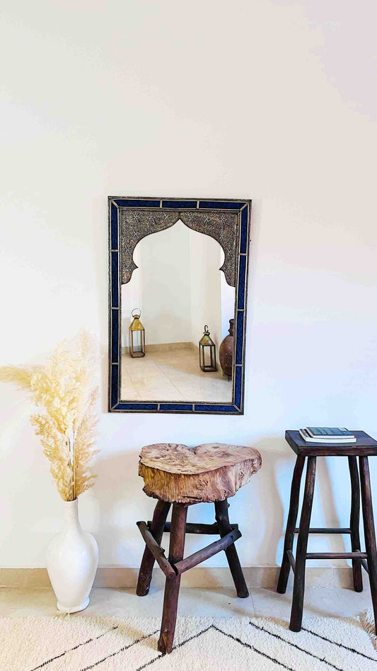 a mirror and stool in a room