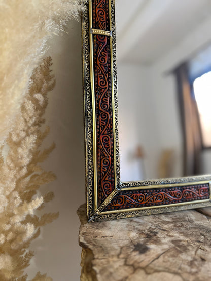 a mirror sitting on top of a wooden table