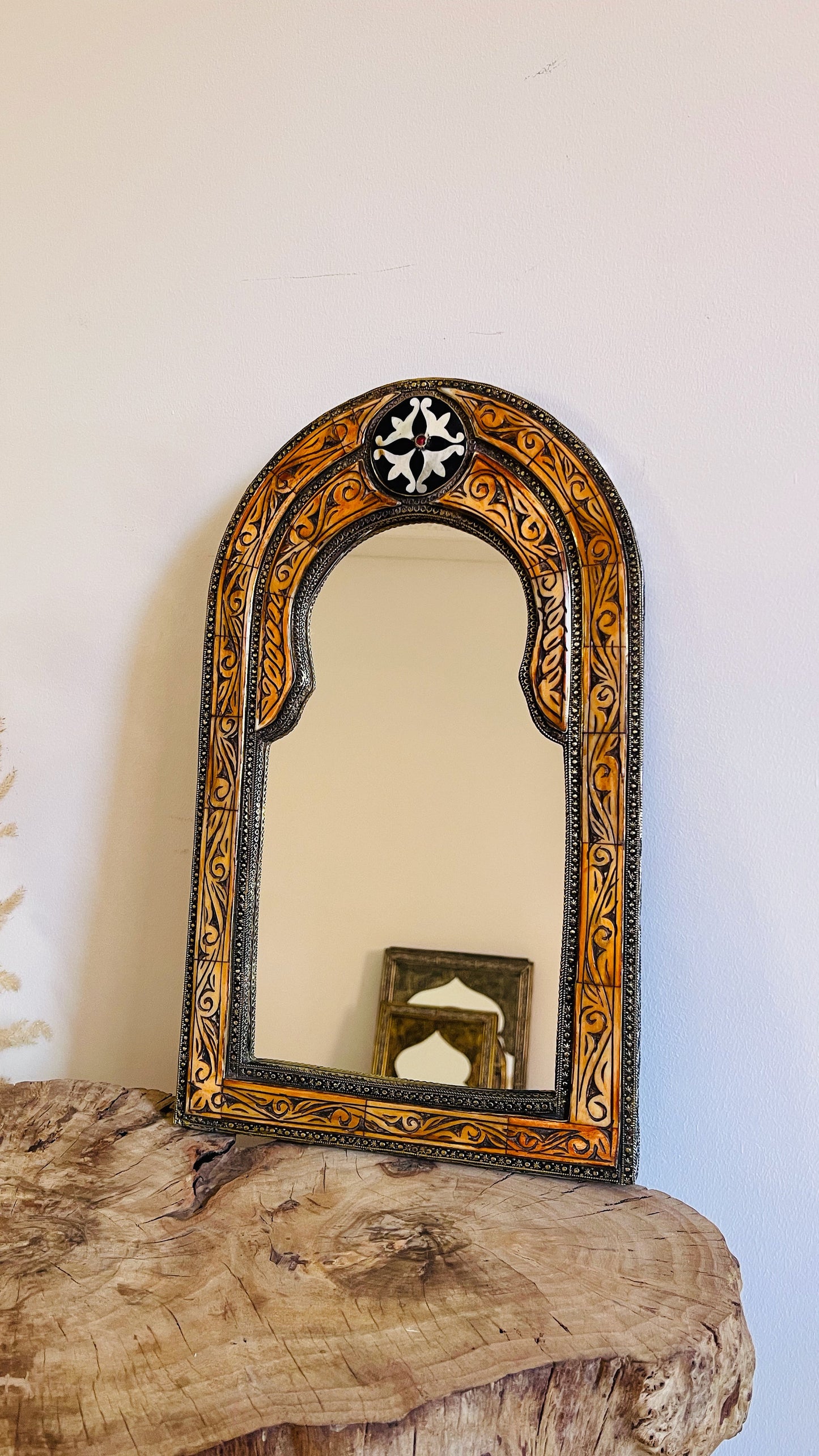 a mirror sitting on top of a wooden table