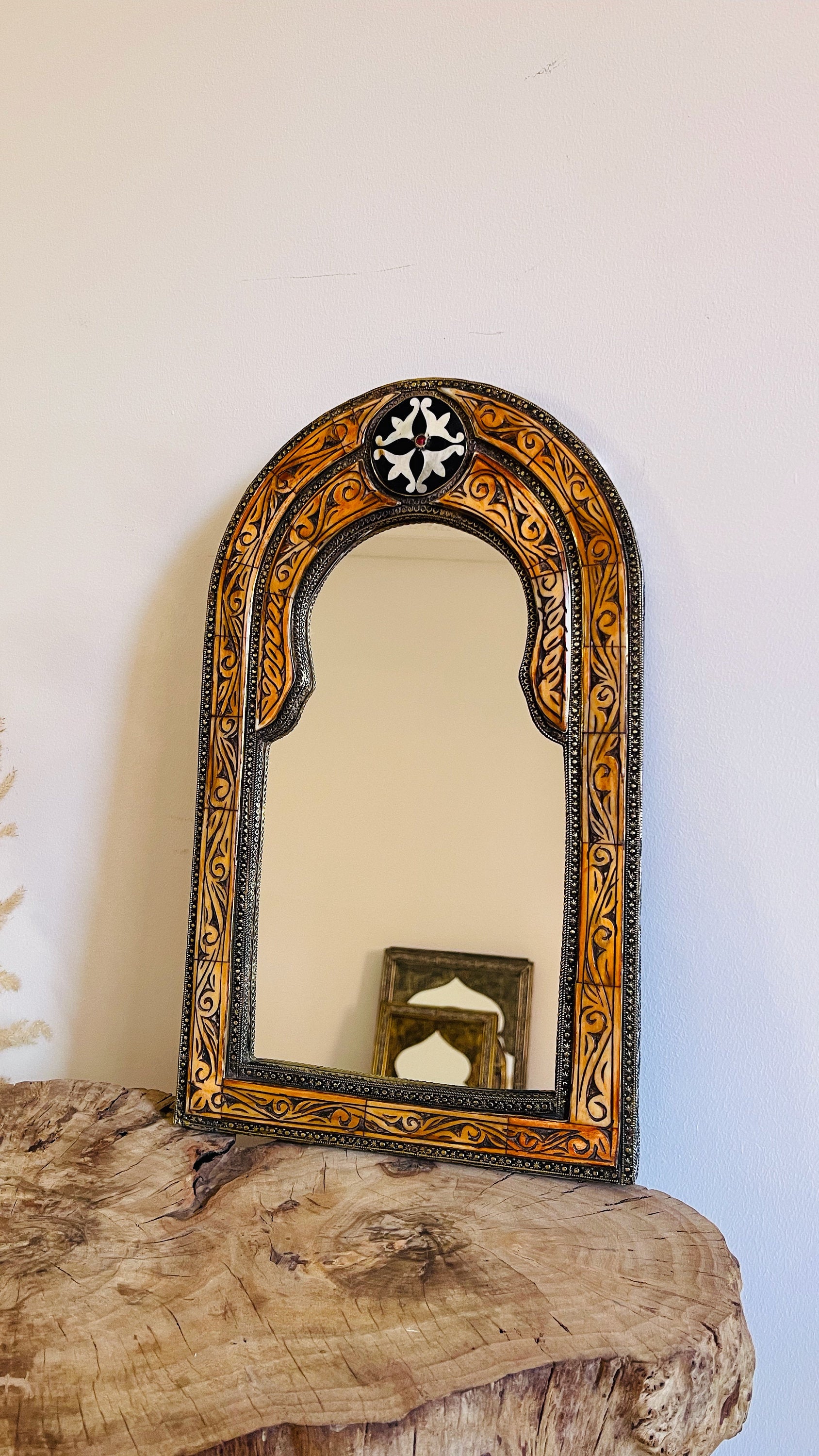 a mirror sitting on top of a wooden table