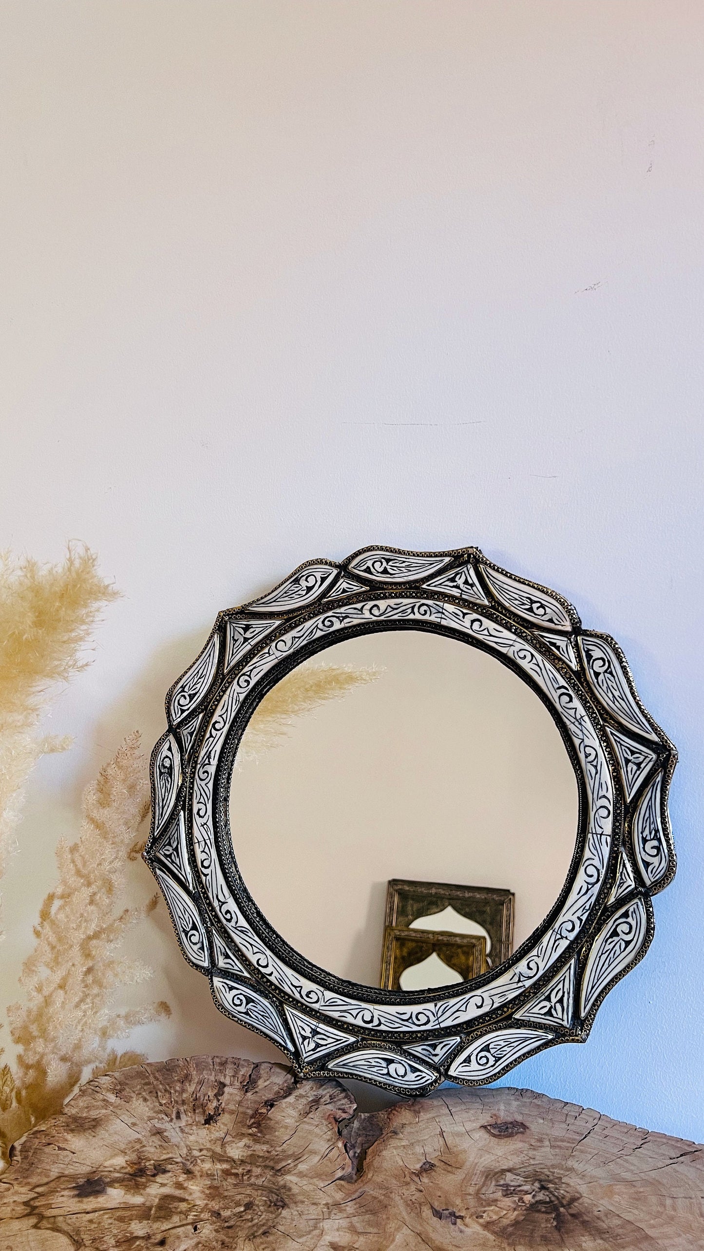 a mirror sitting on top of a wooden table