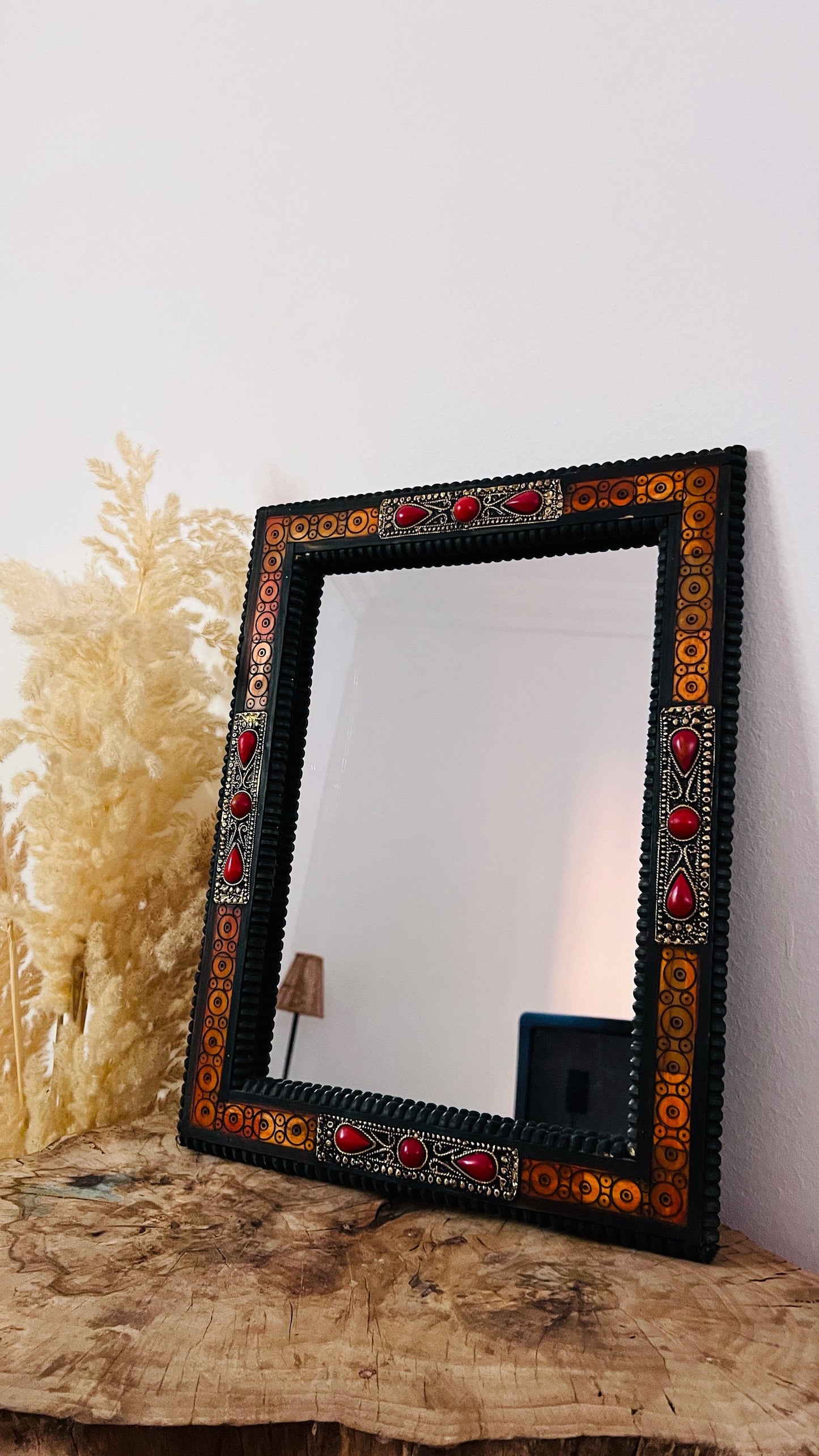 a mirror sitting on top of a wooden table