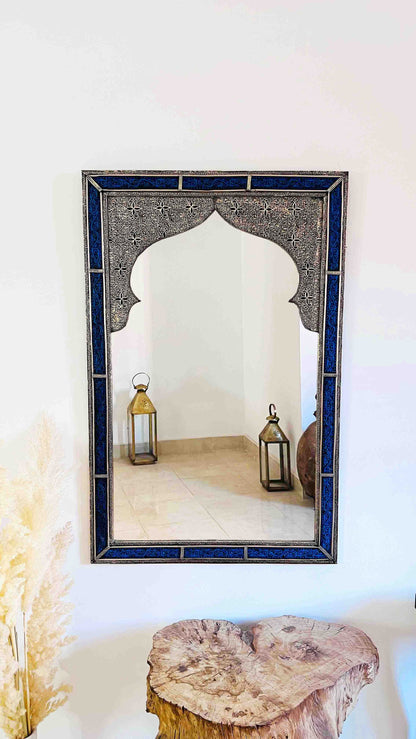a mirror sitting on top of a wooden table