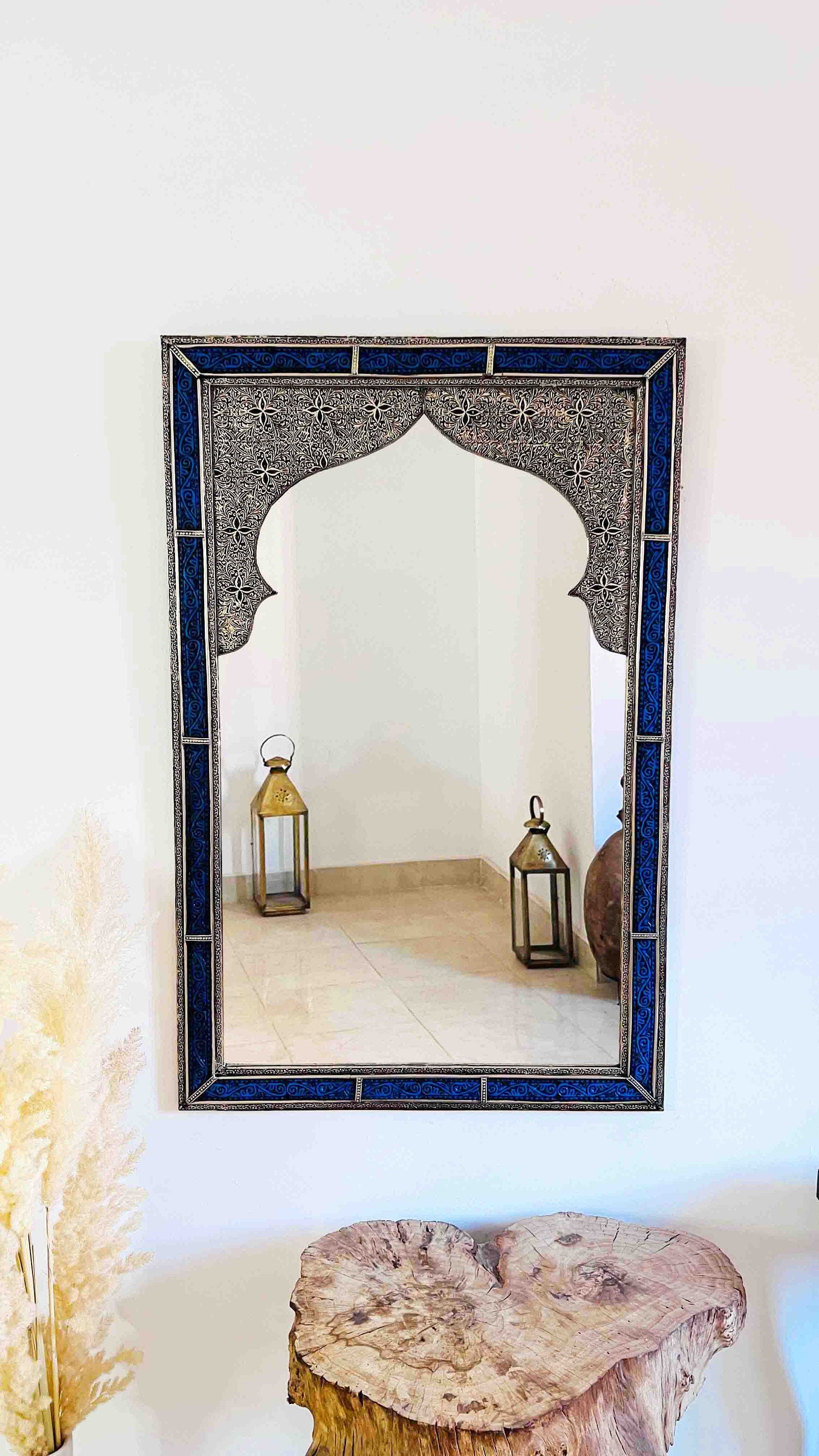 a mirror sitting on top of a wooden table