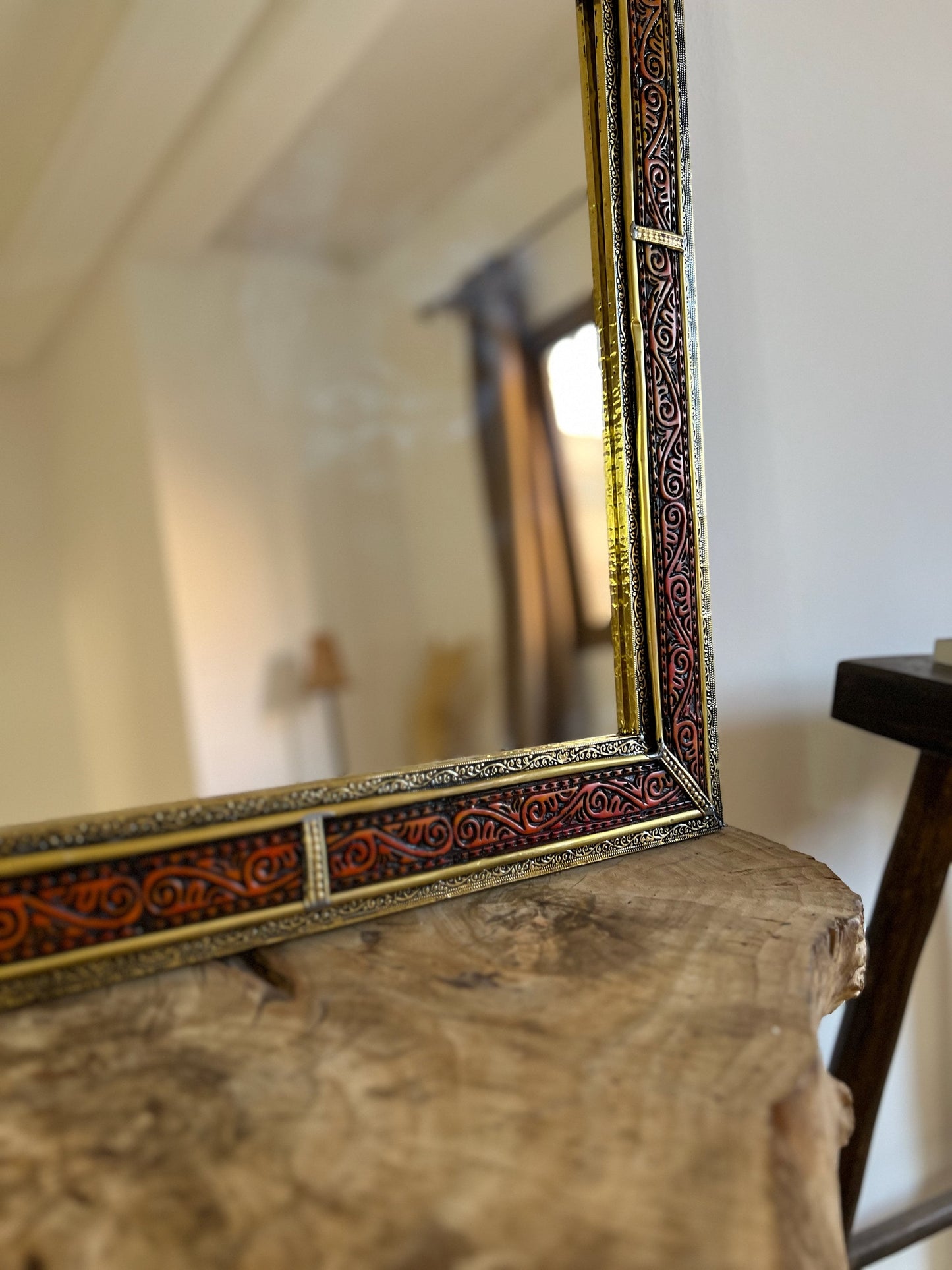 a mirror sitting on top of a wooden table