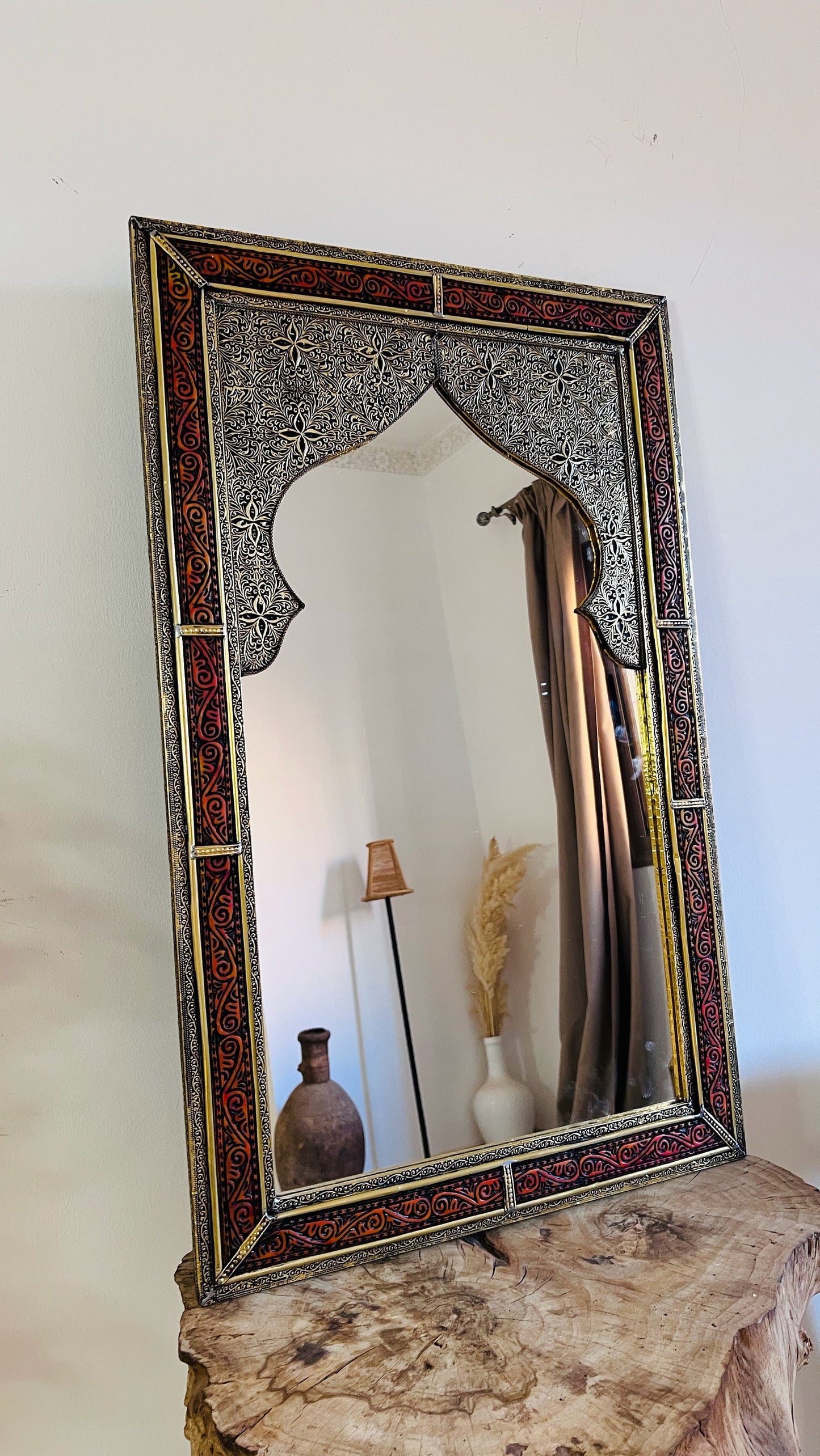 a mirror sitting on top of a wooden table