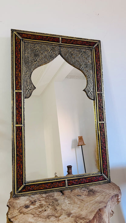 a mirror sitting on top of a wooden table