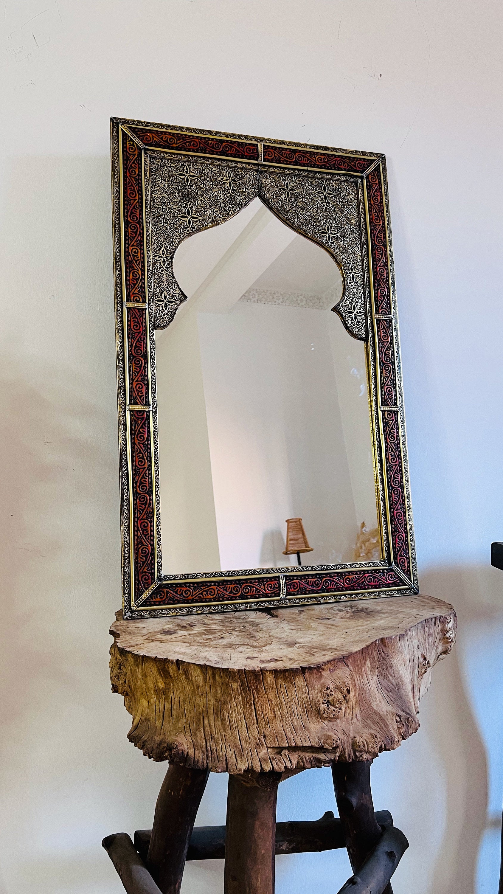 a mirror sitting on top of a wooden table