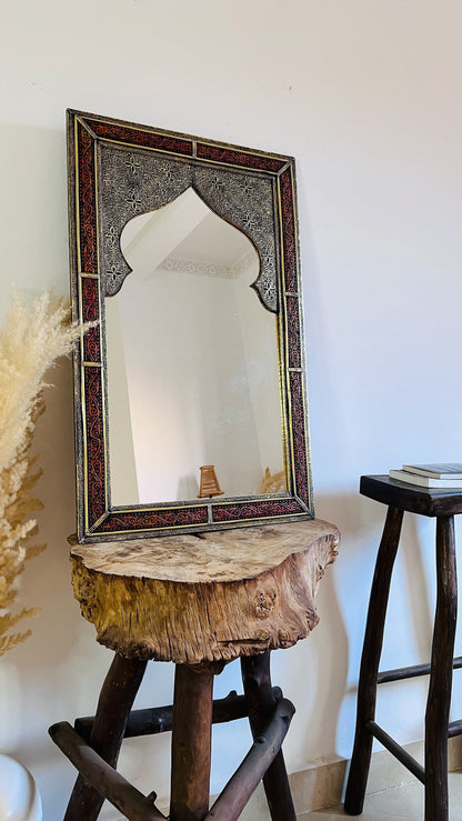 a mirror sitting on top of a wooden stool