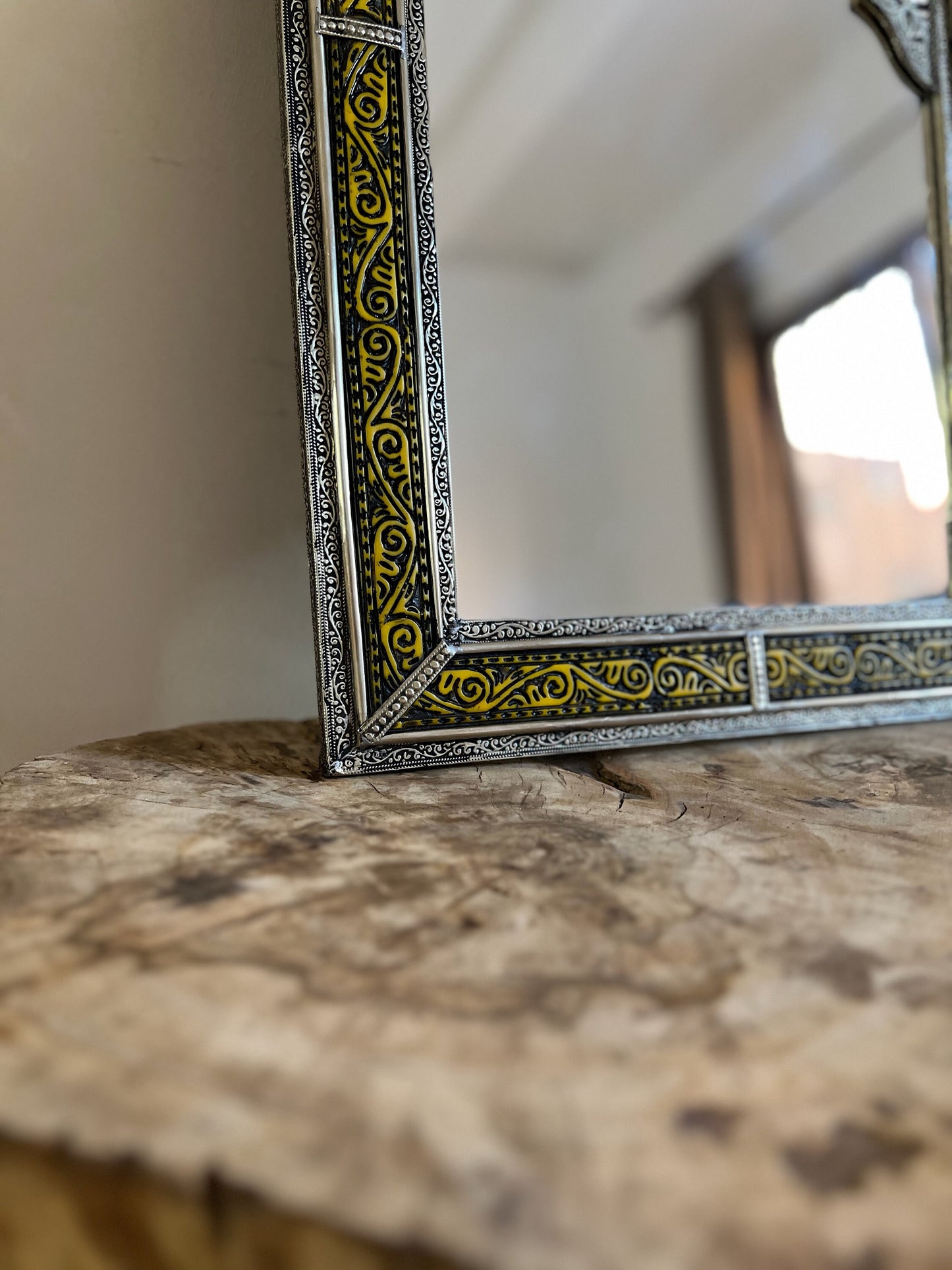 a mirror sitting on top of a wooden table