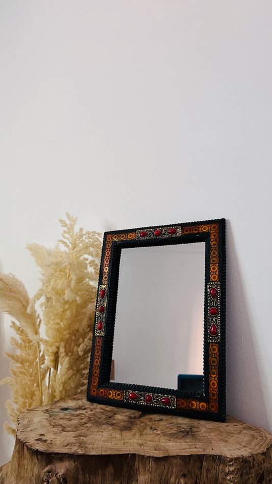 a mirror sitting on top of a tree stump