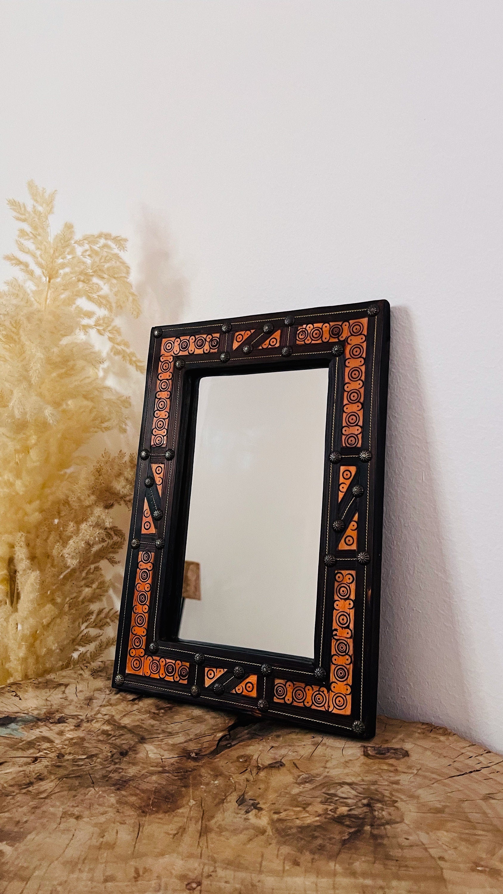 a mirror sitting on top of a wooden table