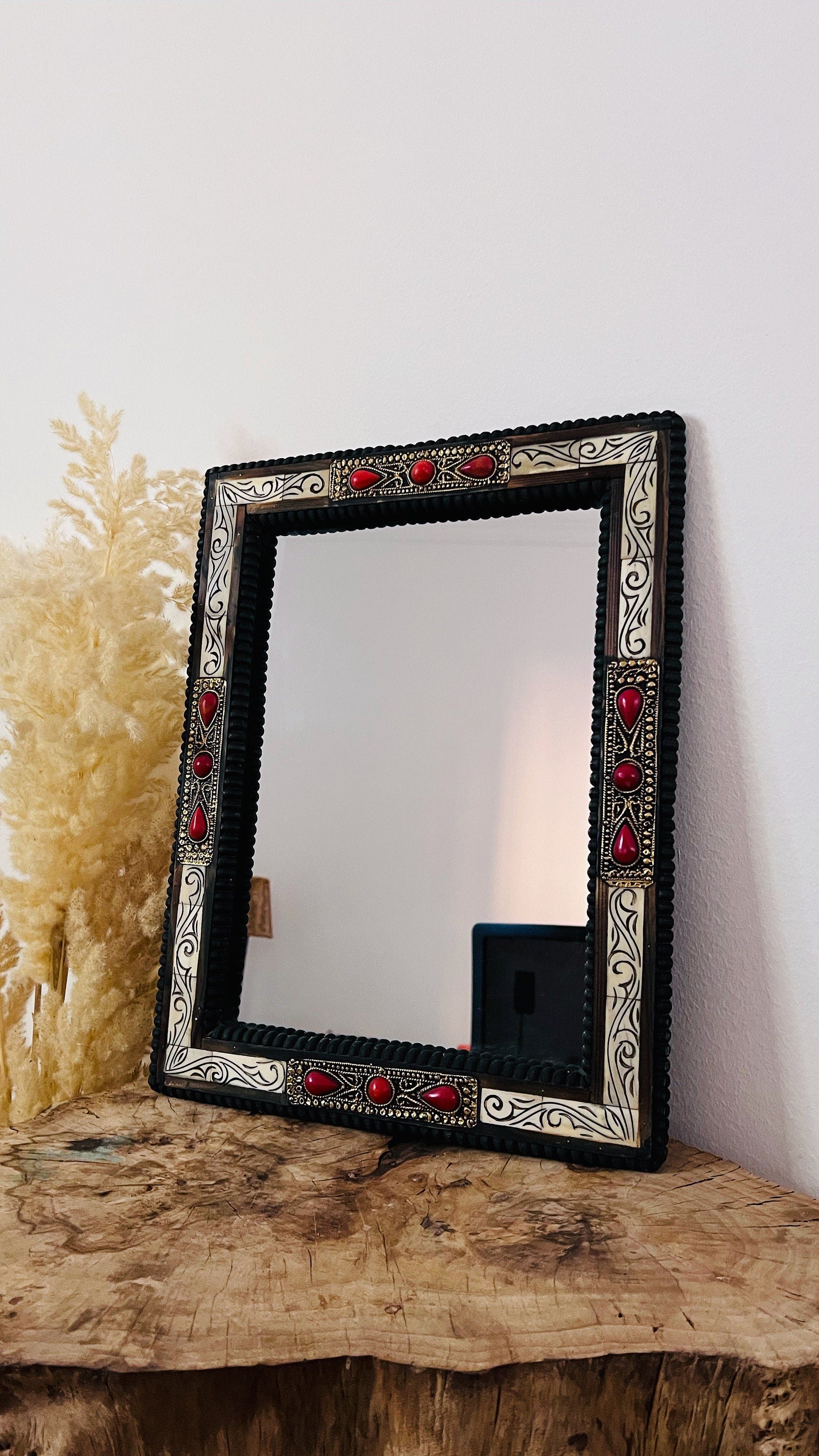 a mirror sitting on top of a wooden table